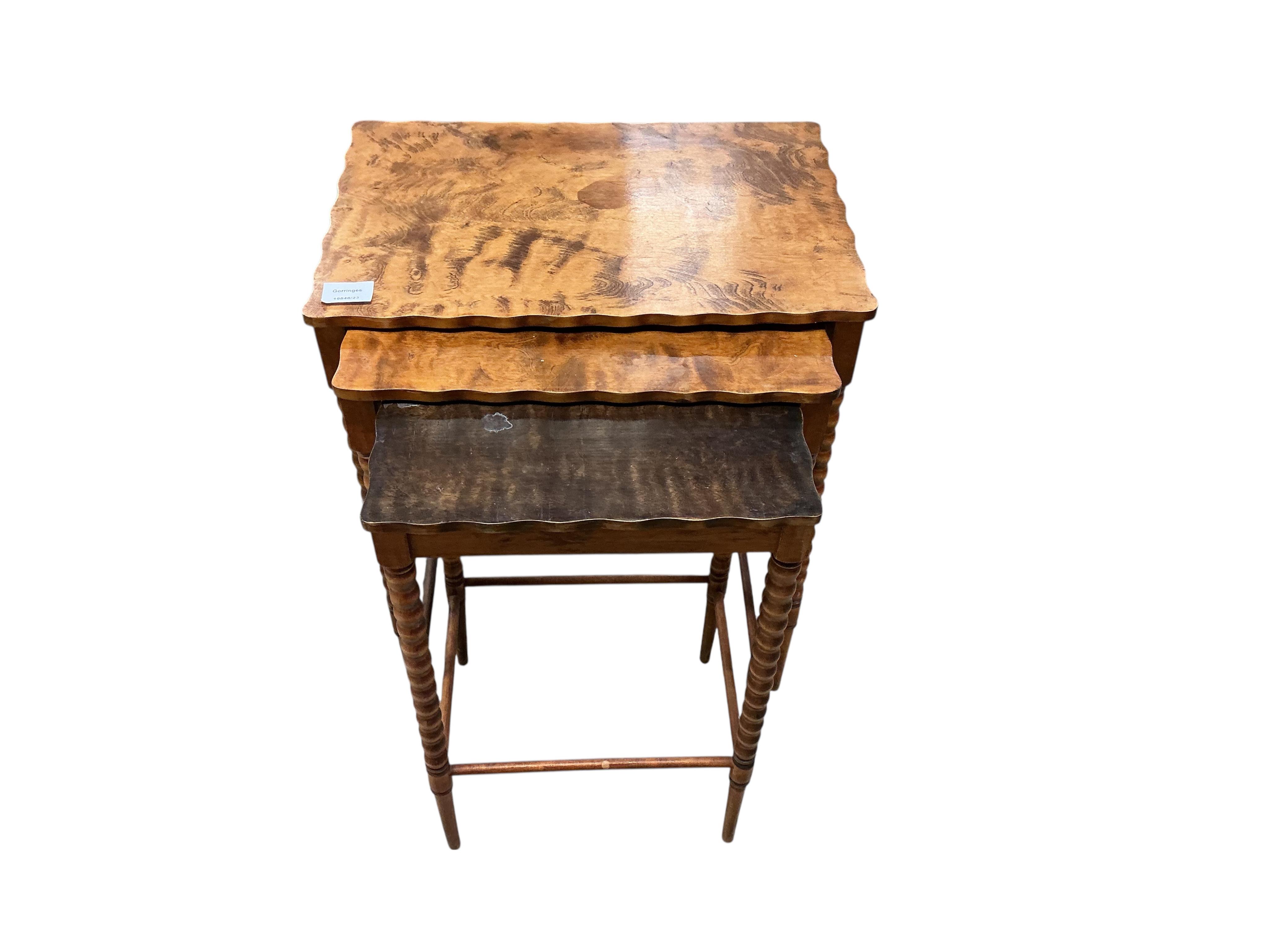 A nest of three rectangular beech tea tables, width 47cm, depth 32cm, height 59cm